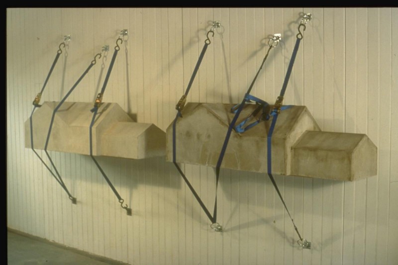  Strapped -Concrete and straps. Each house is 54”x16”x16”. 